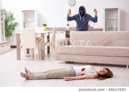 Gangster and young woman in robbery concept Gangster and young woman in robbery concept 66622685