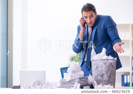 Businessman rejecting new ideas with lots of papers Businessman rejecting new ideas with lots of papers 66623629