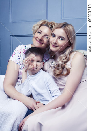 happy smiling blond family together posing cheerful on blue background, generation concept. lifestyle people 66623716