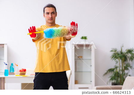 Young male contractor cleaning the house Young male contractor cleaning the house 66624313