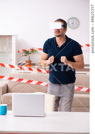 Young man feeling bored at home in self-isolation concept 66625357