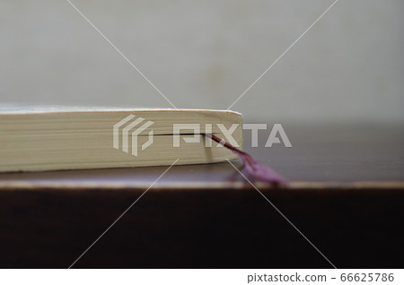A reading book on the desk 66625786