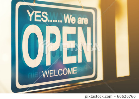 A business sign that says open on cafe or 66626766