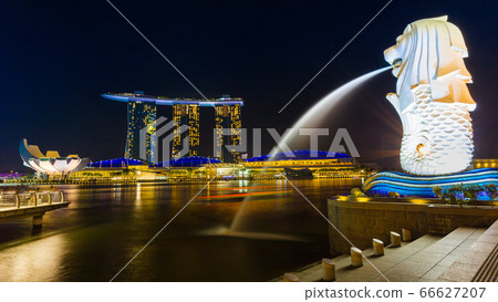 SINGAPORE - NOV 18 2016 : Merlion fountain in front of the Marina Bay Sands hotel on November 18,2016 in Singapore. Merlion is a imaginary creature with the head of a lion, seen a symbol of Singapore 66627207