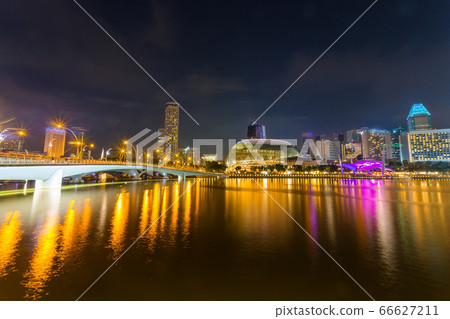 Cityscape of Singapore skyline at night time. Marina Bay is a bay located in the Central Area of Singapore Cityscape of Singapore skyline at night time. Marina Bay is a bay located in the Central Area of Singapore 66627211