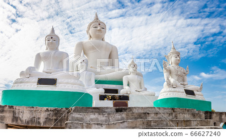 White Buddha on blue sky and cloud background White Buddha on blue sky and cloud background 66627240