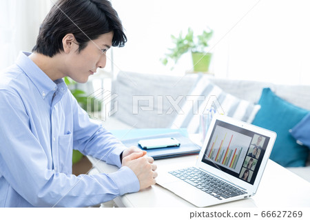 Young men participating in a video conference at home 66627269