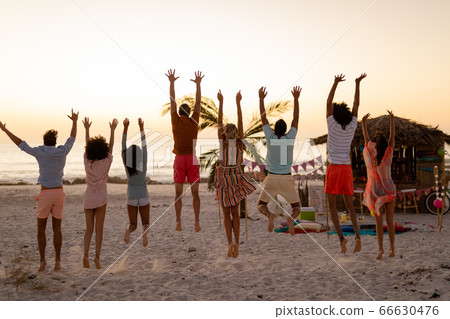 Multi-ethnic group of male and female having fun on the beach Multi-ethnic group of male and female having fun on the beach 66630476