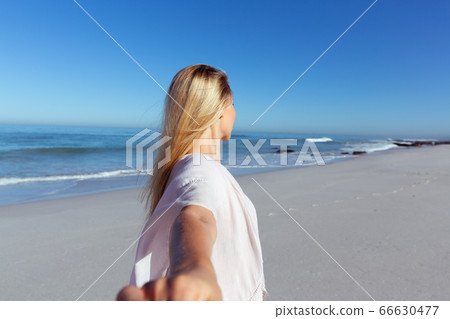 Caucasian woman enjoying at beach Caucasian woman enjoying at beach 66630477