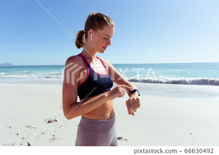 Caucasian woman exercising seaside Caucasian woman exercising seaside 66630492