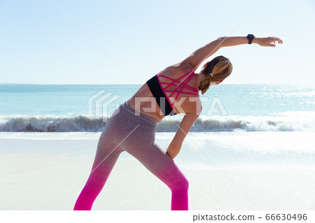 Caucasian woman exercising seaside Caucasian woman exercising seaside 66630496