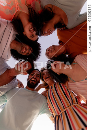 Multi-ethnic group of male and female having fun on the beach Multi-ethnic group of male and female having fun on the beach 66630583