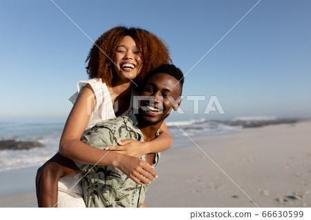Happy couple spending time together on the beach Happy couple spending time together on the beach 66630599