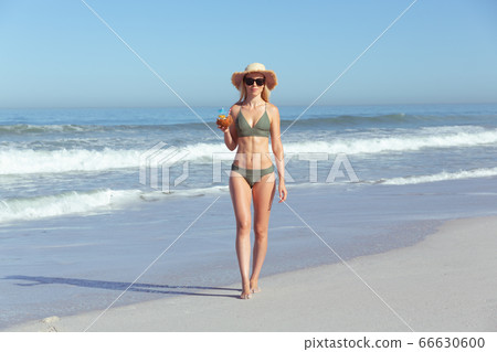 Caucasian woman enjoying at beach Caucasian woman enjoying at beach 66630600