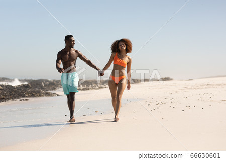 Happy couple spending time together on the beach Happy couple spending time together on the beach 66630601
