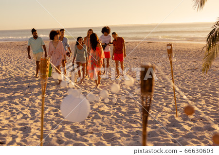 Friends group walking on beach Friends group walking on beach 66630603