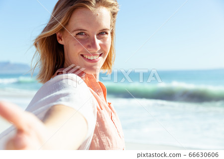 Caucasian woman enjoying time on the beach Caucasian woman enjoying time on the beach 66630606