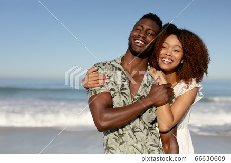 Happy couple spending time together on the beach Happy couple spending time together on the beach 66630609