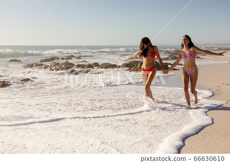 Caucasian women having fun on the beach 66630610