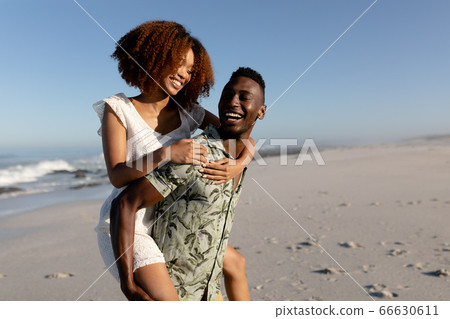 Happy couple spending time together on the beach Happy couple spending time together on the beach 66630611