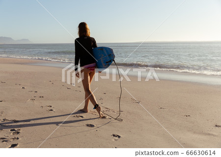 Caucasian woman during surf session at beach Caucasian woman during surf session at beach 66630614