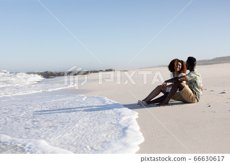 Happy couple spending time together on the beach Happy couple spending time together on the beach 66630617