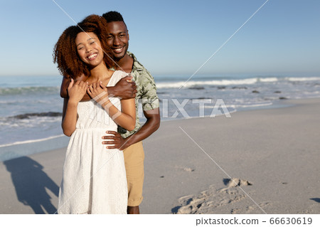 Happy couple spending time together on the beach Happy couple spending time together on the beach 66630619