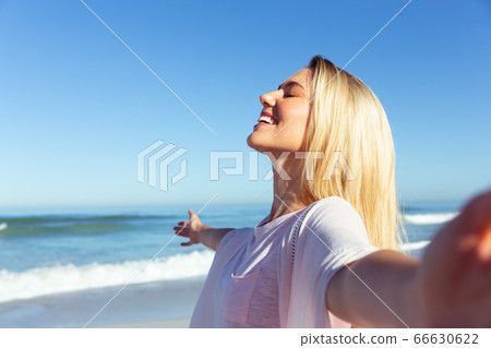 Caucasian woman enjoying at beach Caucasian woman enjoying at beach 66630622