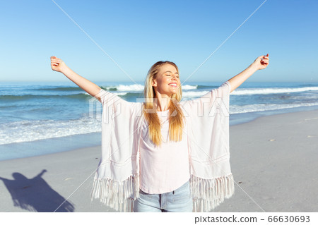 Caucasian woman enjoying at beach Caucasian woman enjoying at beach 66630693