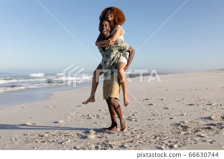 Happy couple spending time together on the beach Happy couple spending time together on the beach 66630744