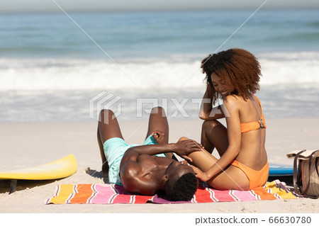 Happy couple spending time together on the beach Happy couple spending time together on the beach 66630780
