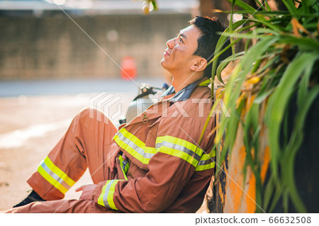 Asian male and female firefighter portrait, young smiling fireman in uniform 374 Asian male and female firefighter portrait, young smiling fireman in uniform 374 66632508