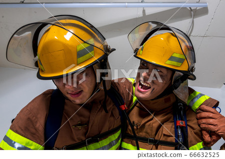 Asian male and female firefighter portrait, young smiling fireman in uniform 479 Asian male and female firefighter portrait, young smiling fireman in uniform 479 66632525