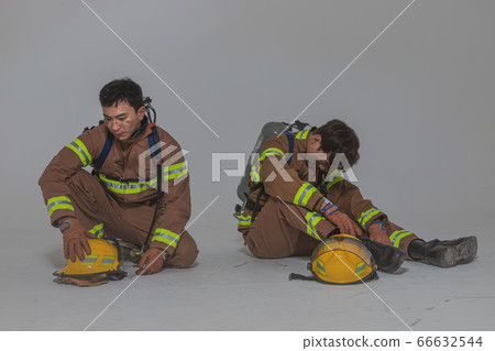 Asian male and female firefighter portrait, young smiling fireman in uniform 522 Asian male and female firefighter portrait, young smiling fireman in uniform 522 66632544