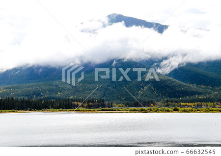 Freight train and Sulfur Mountain (Banff National Park, Canada) alongside Vermilion Lake in autumn Canadian Rockies 66632545