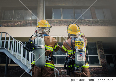 Asian male and female firefighter portrait, young smiling fireman in uniform 289 Asian male and female firefighter portrait, young smiling fireman in uniform 289 66632627