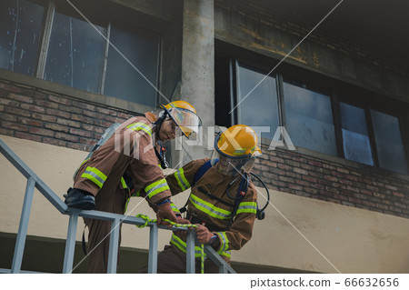 Asian male and female firefighter portrait, young smiling fireman in uniform 293 Asian male and female firefighter portrait, young smiling fireman in uniform 293 66632656
