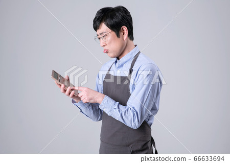 A studio portrait of Asian man making a confident smile 339 A studio portrait of Asian man making a confident smile 339 66633694