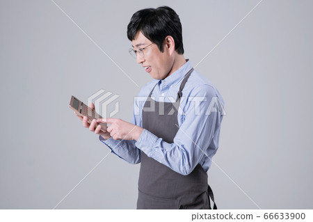 A studio portrait of Asian man making a confident smile 255 A studio portrait of Asian man making a confident smile 255 66633900