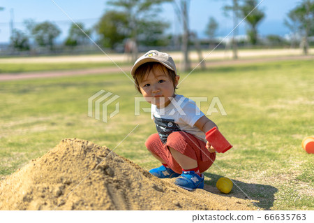 1 year old playing in the park on a sunny day 66635763
