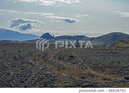 Icelandic lava desert landscape with two hikers 66636791