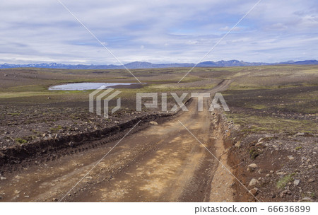 dirt mountain road in abandoned green landscape at dirt mountain road in abandoned green landscape at 66636899