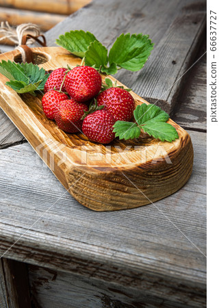 Red strawberries on wooden surface 66637727