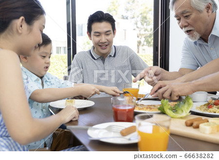 Family surrounding a table Family surrounding a table 66638282