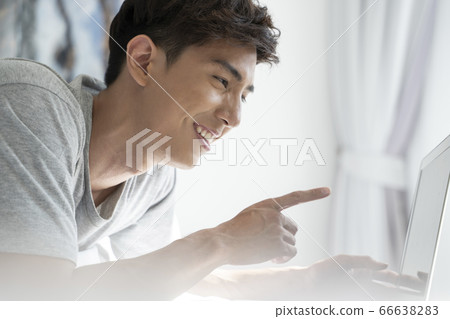 Young men relaxing in the bedroom Young men relaxing in the bedroom 66638283