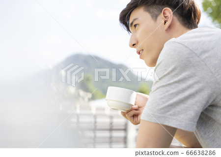 Young men with mugs outdoors Young men with mugs outdoors 66638286