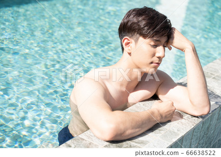 A man relaxing by the pool A man relaxing by the pool 66638522