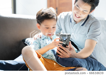 Father and son relaxing indoors 66638639
