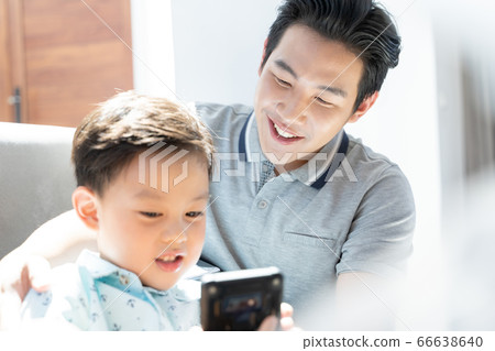 Father and son relaxing indoors 66638640