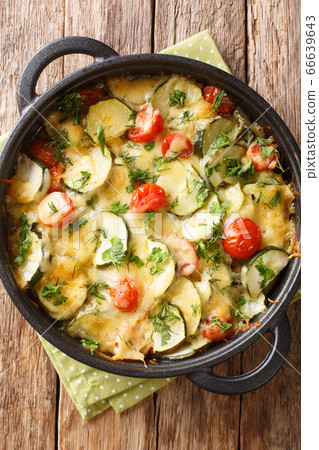 Baked zucchini with cheese and tomatoes close-up 66639643
